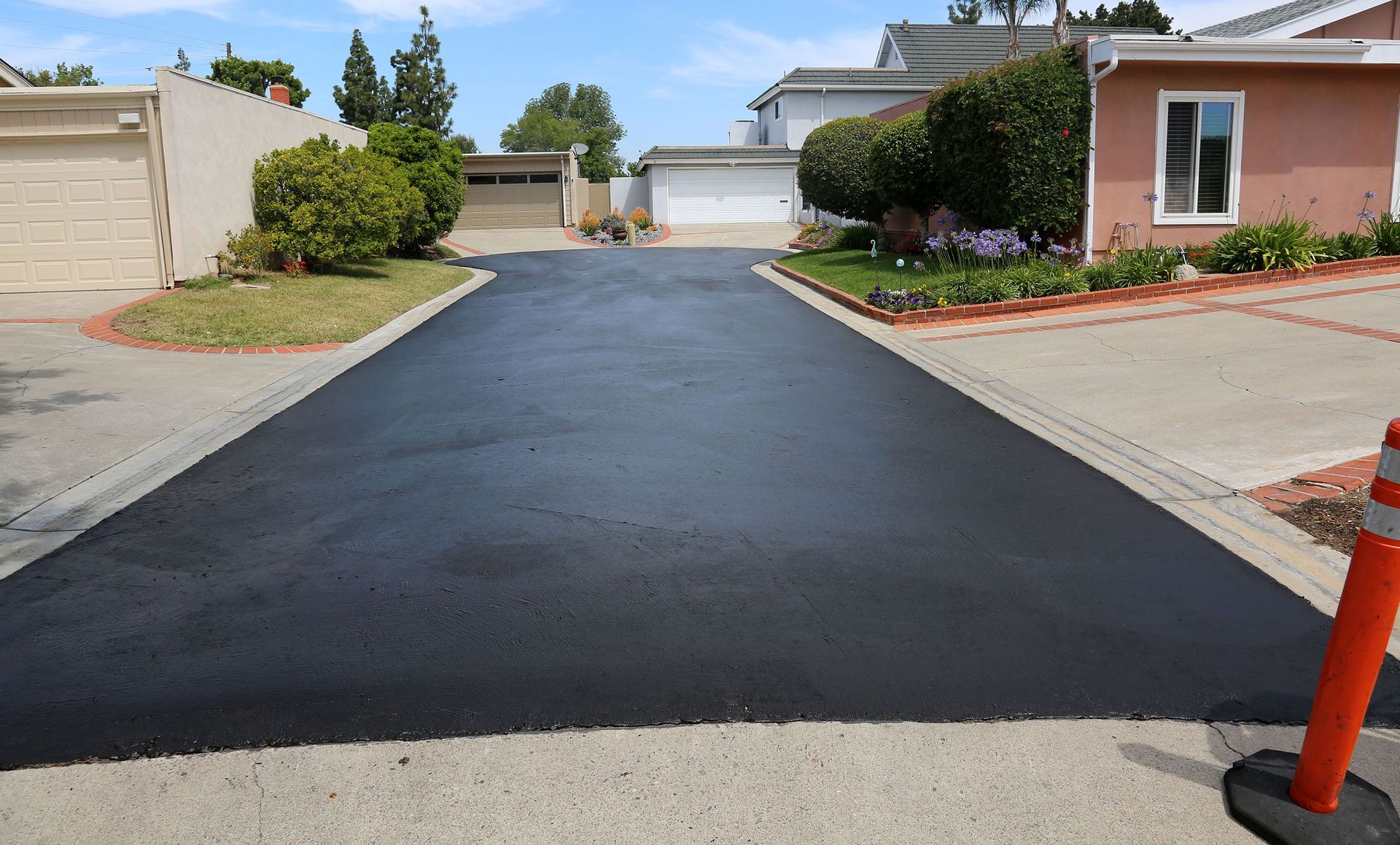 Heavy roller compacting fresh asphalt on a paving job